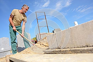 portrait worker digging grave