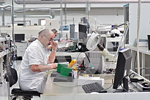 portrait of a worker in the engineering department of a factory for the production and construction of electronics