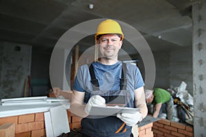 Worker hold clipboard and write down consumable materials for renovation photo