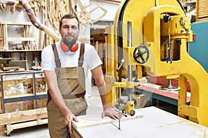 Portrait of a worker in a joinery at the workplace - woodworking