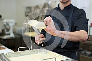 portrait worker making chocolate eggs