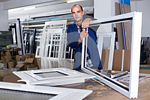 Portrait of workerman assembler of plastic windows