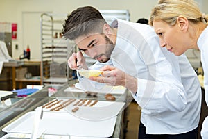 Portrait workers making chocolate photo