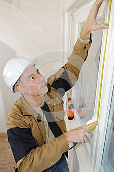 portrait workman measuring window