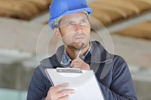 portrait workman preparing estimate for work on house