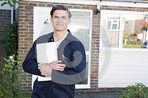 Portrait Of Workman Preparing Estimate For Work On House