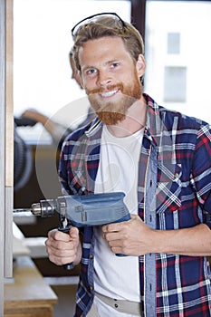 Portrait workman using cordless drill