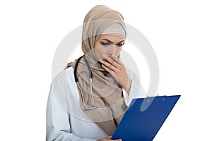 Portrait of worried muslim female Medical doctor holding paperclip isolated