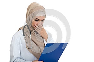 Portrait of worried muslim female Medical doctor holding paperclip isolated