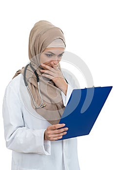 Portrait of worried muslim female Medical doctor holding paperclip isolated