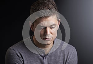 Portrait of a worried young man looking down