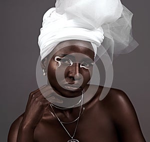 Portrait, wrap and black woman with makeup, beauty and confidence in studio on grey background. Face, glow and proud