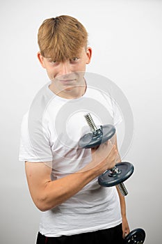 Teenage boy using a dumbbell