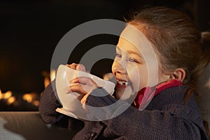 Portrait 7 year old girl by firelight