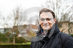 Portrait of a 40 yo white man in winter clothes with anature background