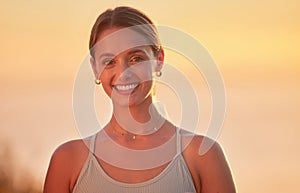 Portrait of yoga woman outside after outdoor practice in remote nature at sunset. Beautiful smiling young caucasian