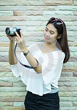 Portrait of yound asian woman with her camera