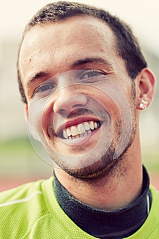 Portrait of a young active man smiling during sport training, exercise