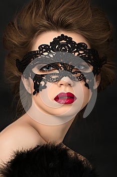 Portrait of young adorable woman in black party mask