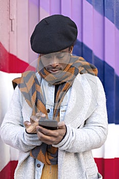 Portrait of young adult African American male using a smart phone