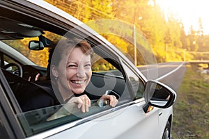 Portrait of young adult beautiful caucasian woman driver enjoy roadtrip adventure traveling by car on mountain nature