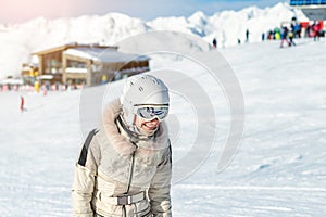 Portrait of young adult beautiful happy caucasian woman smiling near lift station at alpine winter skiing resort. Girl in fashion