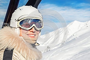 Portrait of young adult beautiful happy caucasian woman smiling on ski-lift at alpine winter skiing resort. Girl in fashion ski