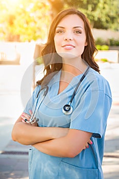 Portrait of Young Adult Female Doctor or Nurse Wearing Scrubs an