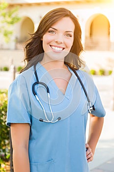 Portrait of Young Adult Female Doctor or Nurse Wearing Scrubs an