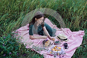 Portrait of young adult female lying on pink blanket