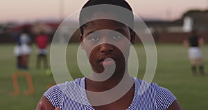 Portrait of young adult female rugby player on a rugby pitch