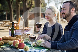 Portrait of young adults drinking wine outdoors