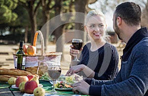 Portrait of young adults drinking wine outdoors