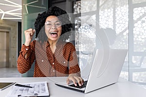 Portrait of a young African American Inca woman working in the office using a laptop, happy and celebrating success to