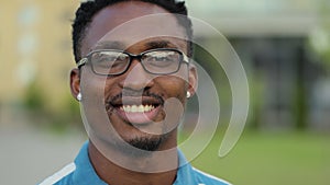 Portrait of young African American man with beard in glasses looking at camera. Portrait of a happy handsome young man