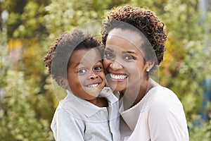 Portrait of young African American mother with toddler son photo