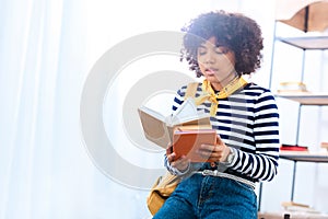 portrait of young african american student with books