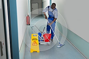 Male Janitor Cleaning Floor