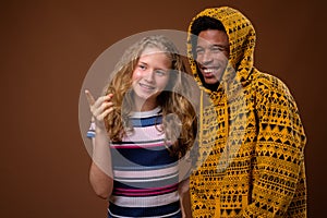 Portrait of young African man and Caucasian teenage girl smiling