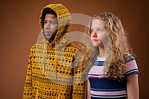 Portrait of young African man and Caucasian teenage girl thinking