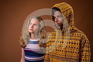 Portrait of young African man and Caucasian teenage girl thinking