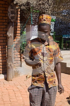 Portrait of a young African man looking at mobile phone.