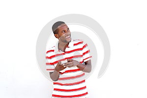 Young african man with mobile phone looking away