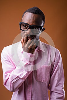 Portrait of young African man picking up his nose