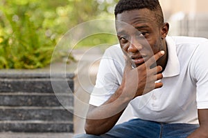 Portrait of young African man thinking in the city outdoors