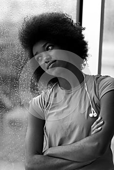 Portrait of young afro american woman in gym while listening mus