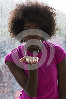 Portrait of young afro american woman in gym while listening mus