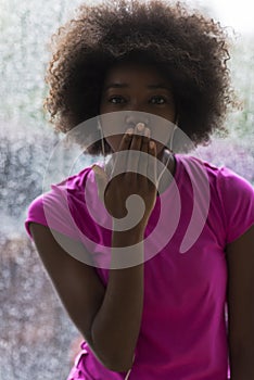 Portrait of young afro american woman in gym while listening mus