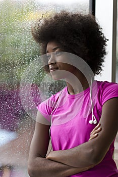 Portrait of young afro american woman in gym while listening mus