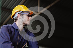 Portrait of young American happy worker in safety clothes engineer hardhat helmet with copy space
